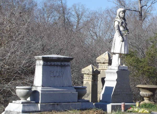 The statue of the little girl is her grave.  Dan placed the rose in her left arm.  It appeared she already had visitors!